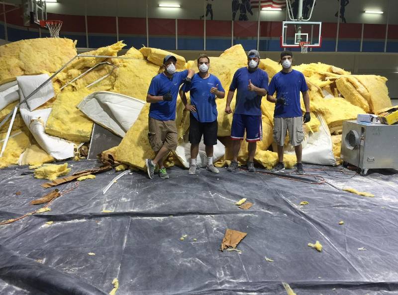 Staff cleaning mold in gym